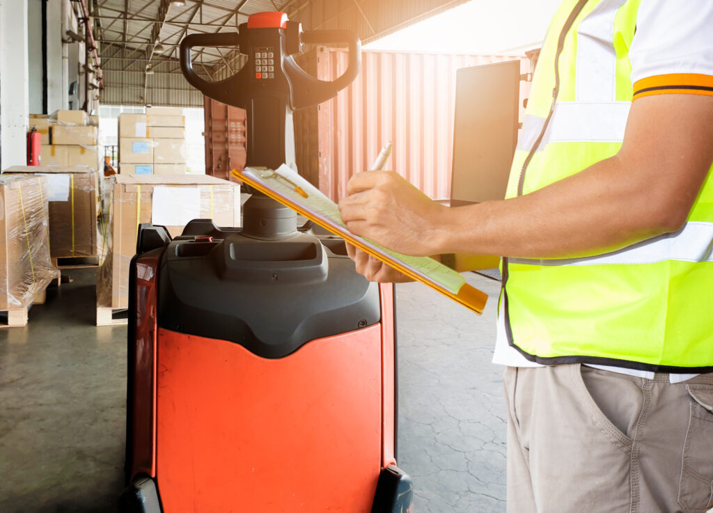 Man inspecting forklift
